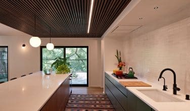 More counterspace for working, eating and serving on modern kitchen island. Remodel by Owings Brothers.