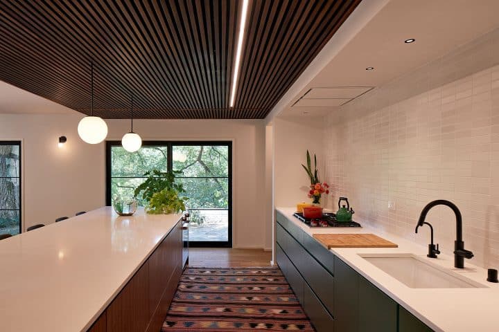 More counterspace for working, eating and serving on modern kitchen island. Remodel by Owings Brothers.