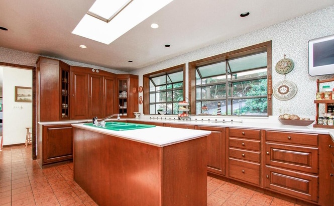 transitional kitchen in gray and white with blue glass tile backsplash