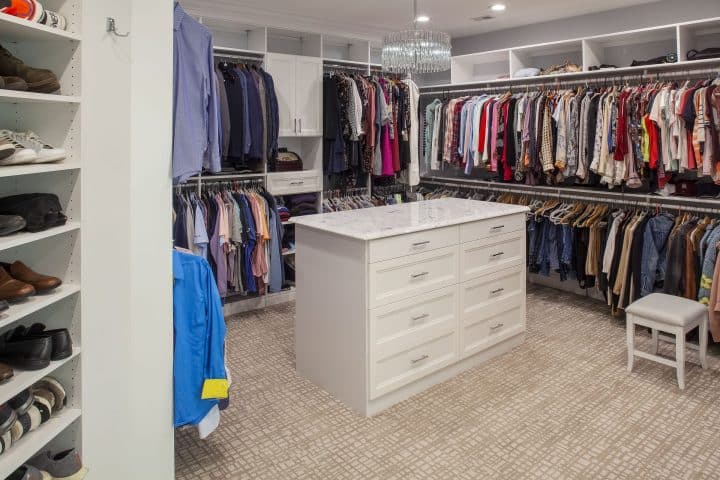 custom walk in closet nestled between bedroom and bath