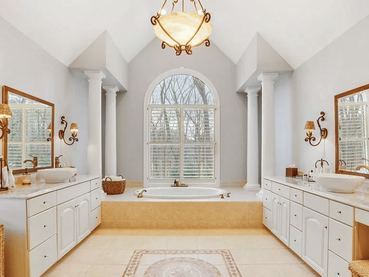 large arched window in master bathroom shower