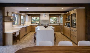 large u-shape kitchen with natural light and adjacent dining area