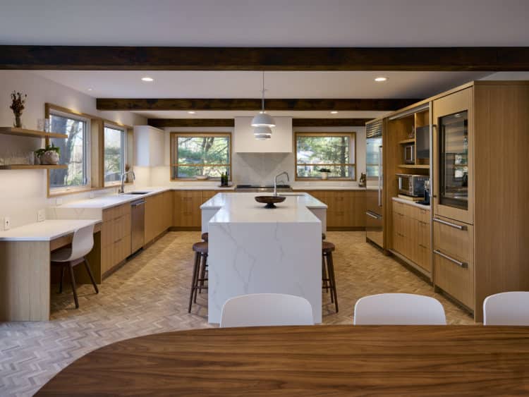 large u-shape kitchen with natural light and adjacent dining area