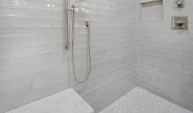 large tiled walk in shower with shower seat