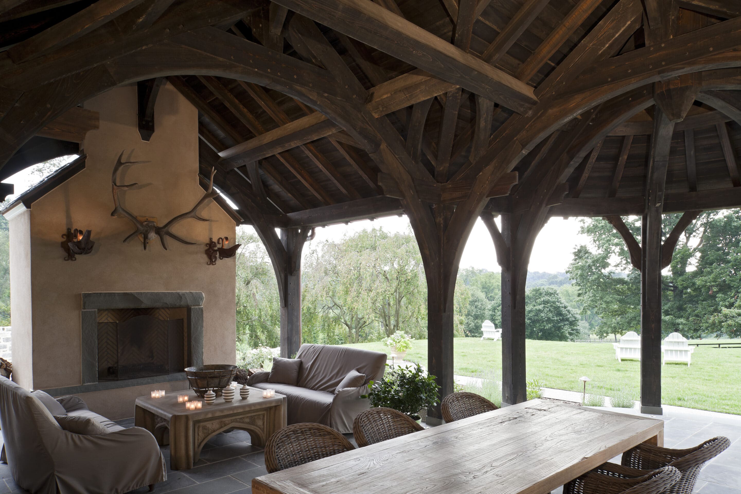 timber trussed covered patio with fireplace
