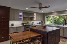 painted neutral glass front lighted perimeter kitchen cabinetry