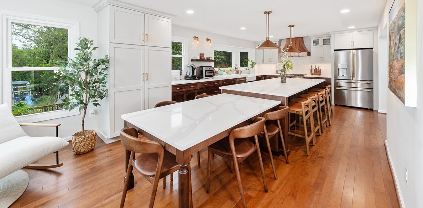 large kitchen island, dining counter, warm wood cabinets, white painted cabinets, copper hood and hardware