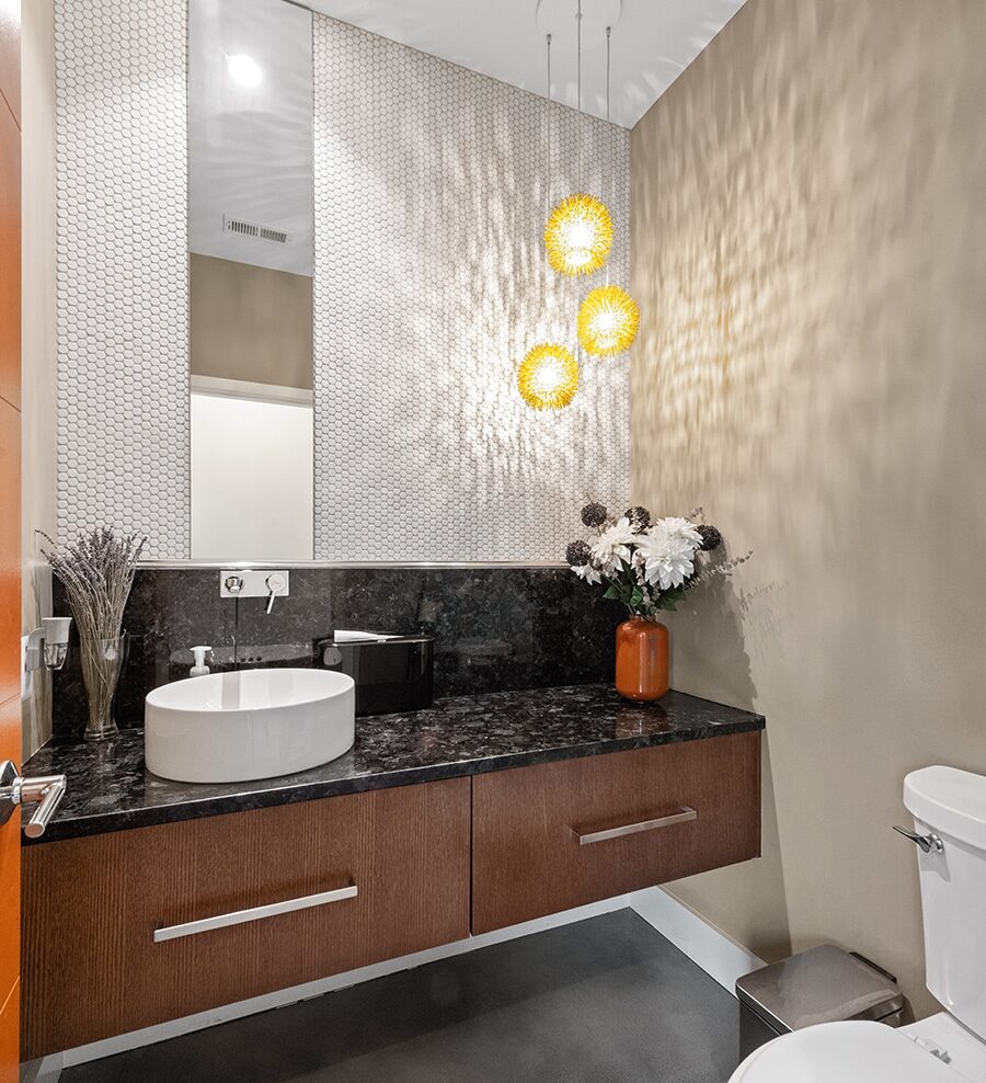 Powder room, beautiful granite counter, raised bowl sink and modern light fixture